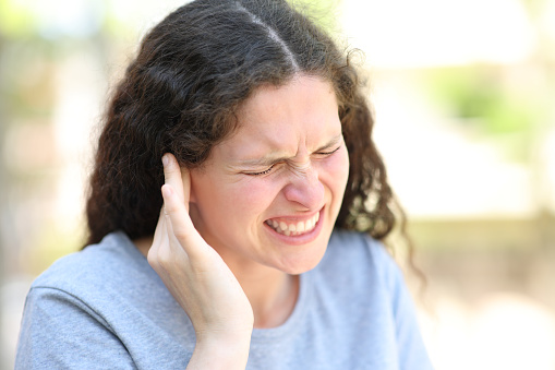 Woman complaining suffering ear ache