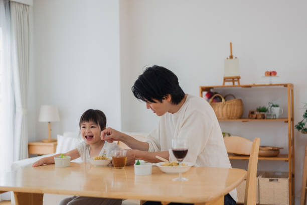 istock Dad eating a meal with his daughter 1403992926
