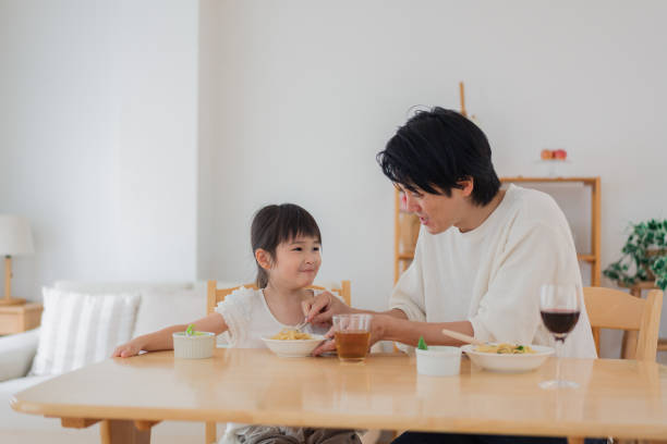 istock Dad eating a meal with his daughter 1403992927