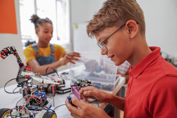 istock Close-up of young STEM class students working robots 1403993619