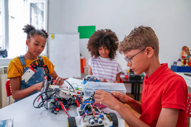 istock Close-up of young STEM class students working robots 1403993646