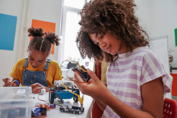 istock Close-up of young STEM class students working robots 1403994239
