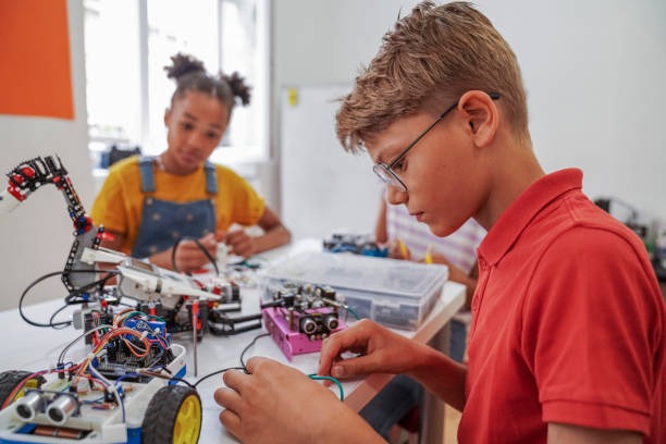 istock Close-up of young STEM class students working robots 1403994244