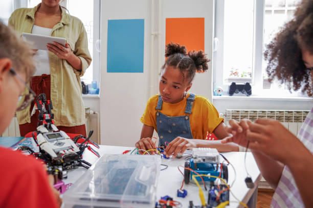 istock Close-up of young STEM class students working robots 1403994346