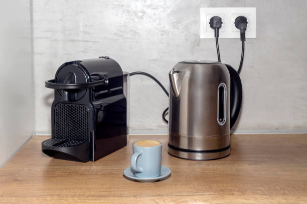 istock New, large, modern electric kettle, coffee machine and cup with cappuccino close-up 1403994483