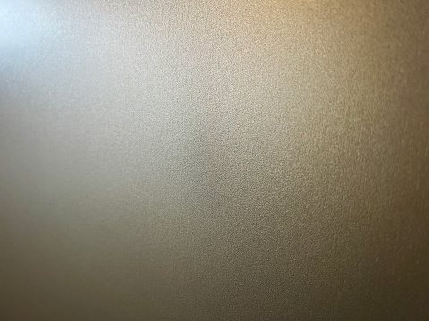 A macro image of a white wallpaper in the dark as a texture or background.