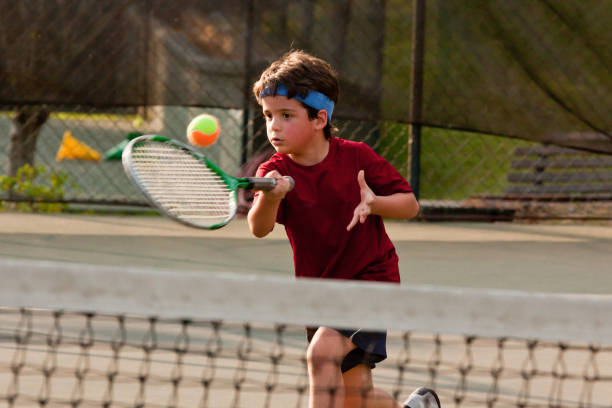 istock Child playing tennis 1403995245