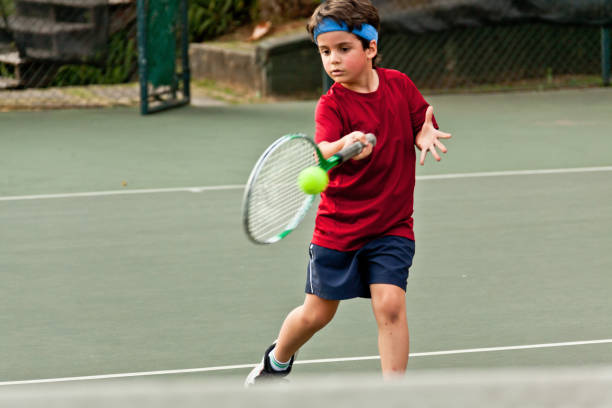 istock Child playing tennis 1403995248
