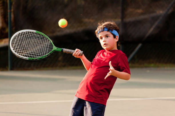 istock Child playing tennis 1403995287
