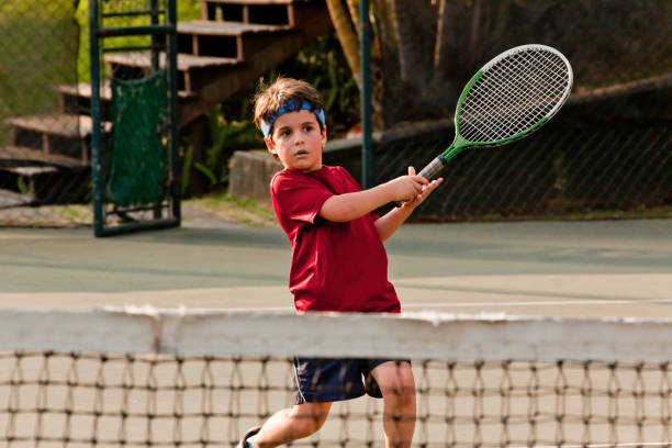 istock Child playing tennis 1403995289