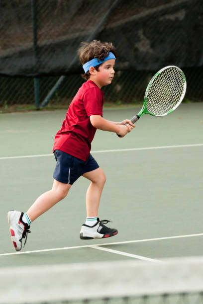 istock Child playing tennis 1403995299