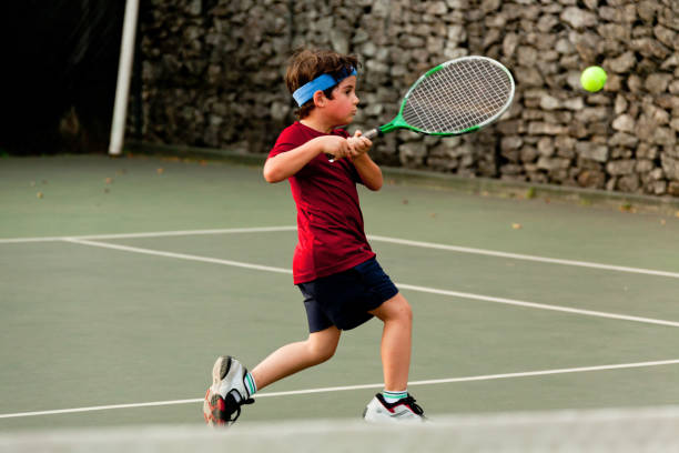 istock Child playing tennis 1403995339