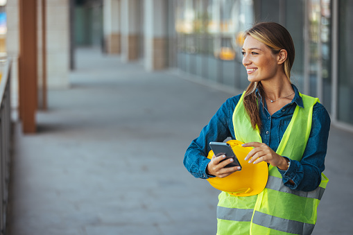 Shot of a young engineer using a smartphone in an industrial place of work