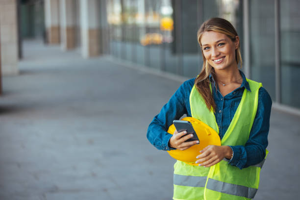 istock Shot of a young businesswoman using his smartphone while on a construction site 1403995346