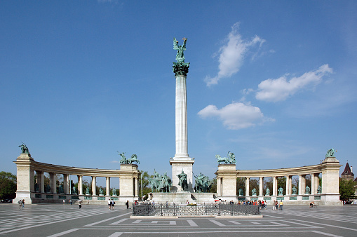 The statue of Archangel Gabriel in Heroes' Square, Budapest, Hungary. Architect Albert Schieckedanz created the square for 1896 Hungarian millennium celebrations.  At the base of Gabriel's column is Arpad and the chieftains of the seven Magyar tribes who followed him. Behind the pillar the Millennium Memorial contains staues of the kings and heroes from Hungarian history. 