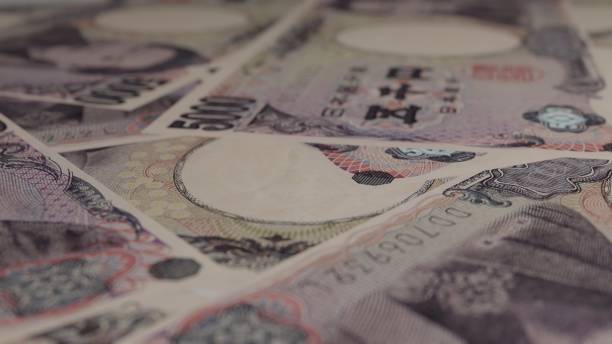 istock 5000 Japanese yen bills background. Many banknotes. 1403996498