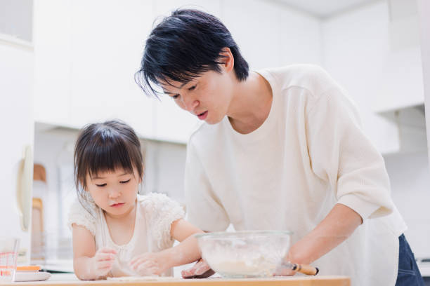 istock Dad kneading dough with his daughter 1403996539