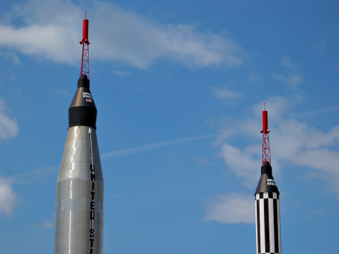 Display of the rockets used for Project Mercury, the initial U.S. manned space program, from 1961 to 1963. Left: Mercury-Atlas (with mockup Mercury capsule) similar to that used in John Glenn's 20 Feb 1962 orbital flight. Right: Mercury-Redstone replica (with mockup Mercury capsule) similar to that used in Alan Shepard's 5 May 1961 suborbital flight.
