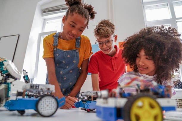 istock Happy kids programming electric toys . 1403997378