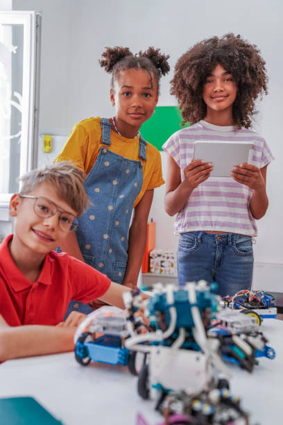 Happy kids programming electric toys .