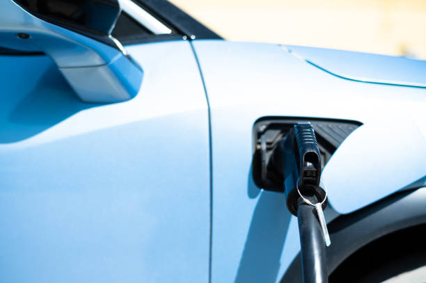 istock Electric vehicle and charging plug, electric vehicle is charging 1403998191