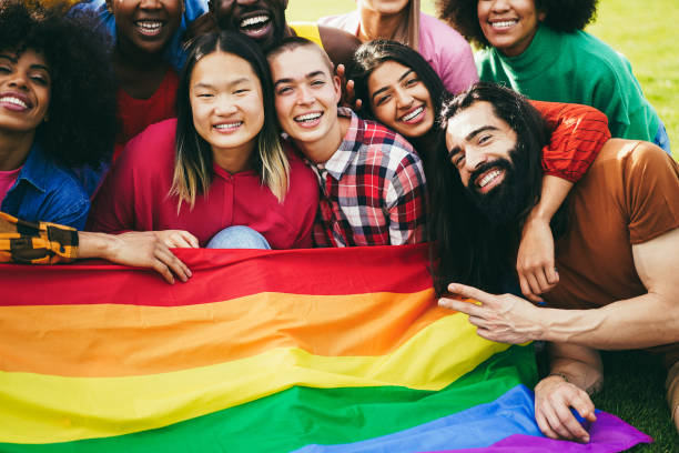 istock Diverse people having fun holding LGBT rainbow flag outdoor 1403998580