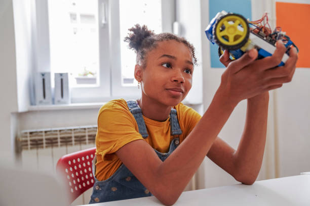 Cute girl with afro hair at the STEM class stock photo