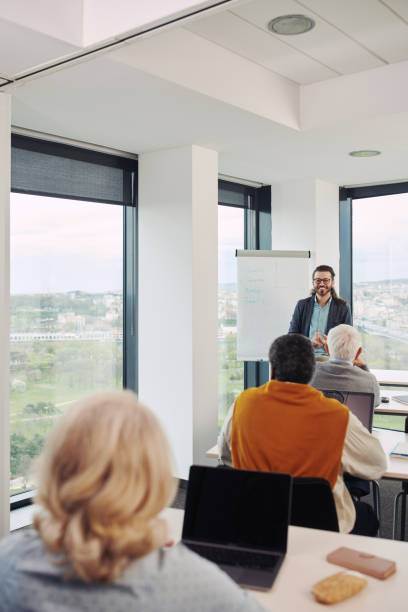 istock A young teacher teaching a small group of senior students in a classroom. 1403999870