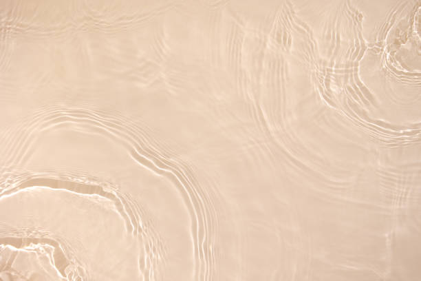 istock transparent beige colored clear calm water surface texture 1404000322