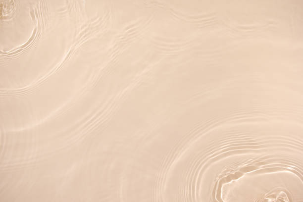istock transparent beige colored clear calm water surface texture 1404001177