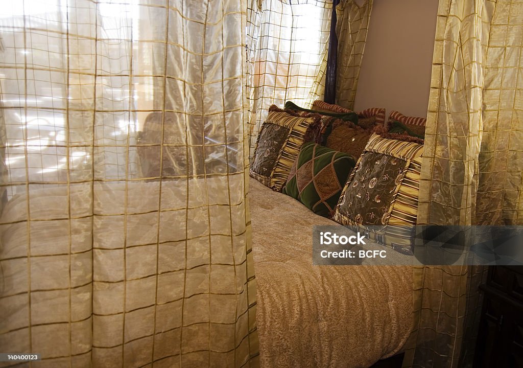 Luxury Bedroom Luxury Bedroom with Four Poster Bed Draped in fine lace. Beauty Stock Photo