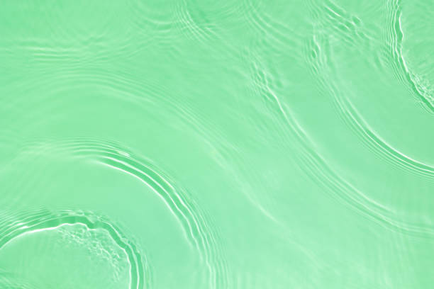 istock transparent green colored clear calm water surface texture 1404001401