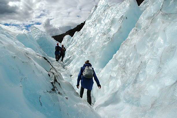 Three hikers in Franz Josef Glacier, New Zealand Beautiful guided walk on the impressive Franz Josef Glacier.South-Island, New Zealand. franz josef glacier photos stock pictures, royalty-free photos & images