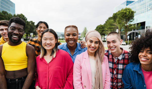 Young diverse people having fun outdoor laughing together - Focus on african girl face stock photo