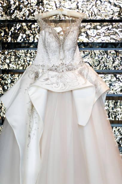 istock Wedding dress hanging on a silver wall 1404004271