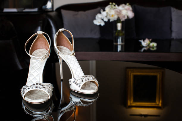 istock Wedding shoes with jewels on a mirror table 1404004437