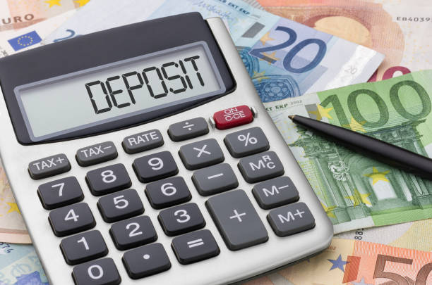 istock Calculator with money and a pen - Deposit 1404004593