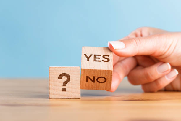istock Female hand change Yes or No wooden cube block 1404004603