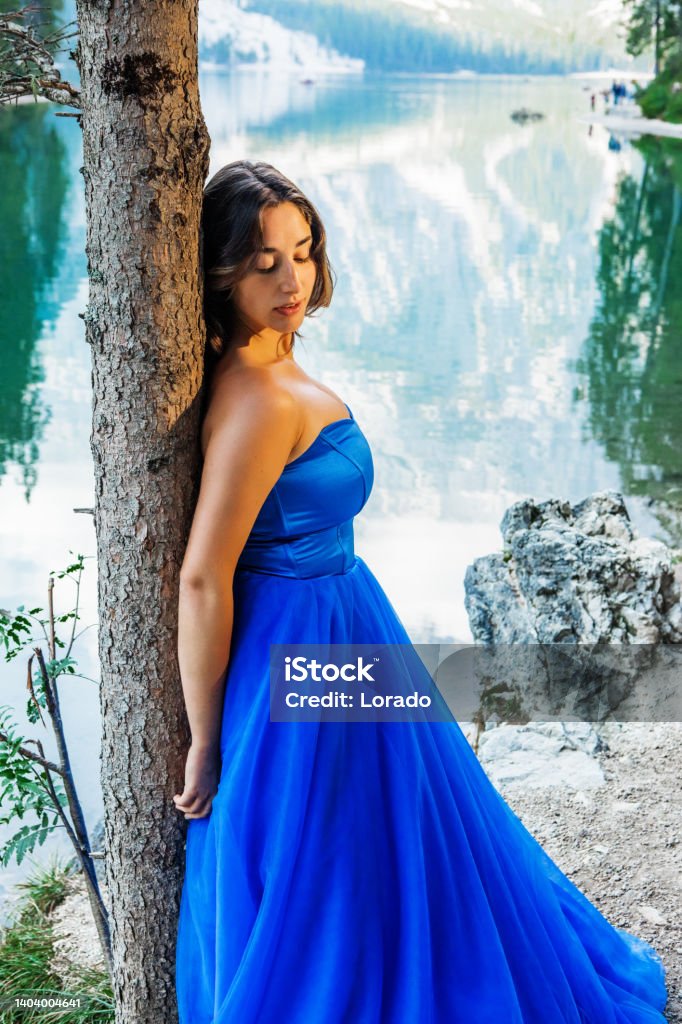 A beautiful brunette princess at a picturesque lake setting A beautiful brunette princess at a picturesque lake setting in Northern Italy Fairy Tale Stock Photo
