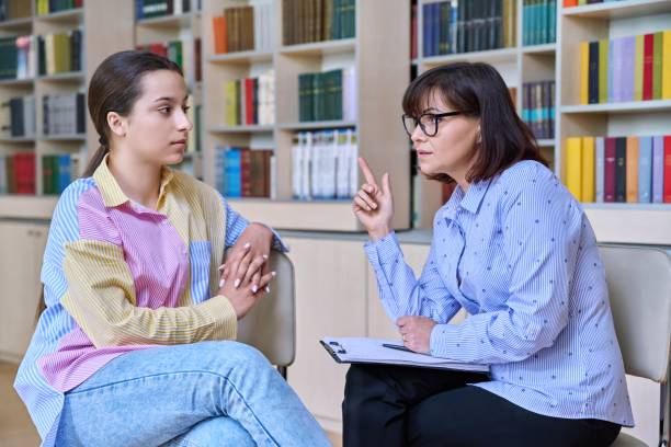 istock Psychologist, high school behavior counseling teenage student in library 1404005405