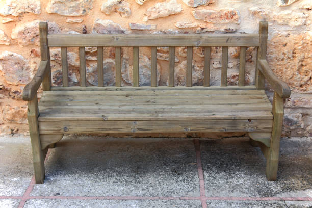 istock old wooden bench near stone wall 1404005427