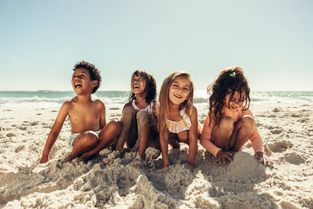istock Four young friends having fun on beach sand 1404005514