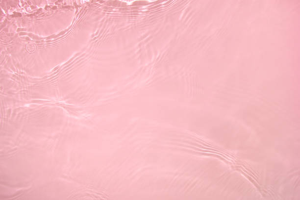 istock transparent pink colored clear calm water surface texture 1404006305
