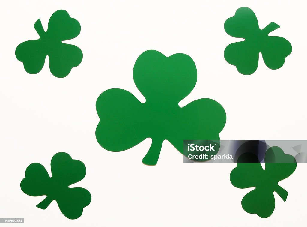 St Patricks Day shamrocks five green paper shamrocks arranged over white Backgrounds Stock Photo