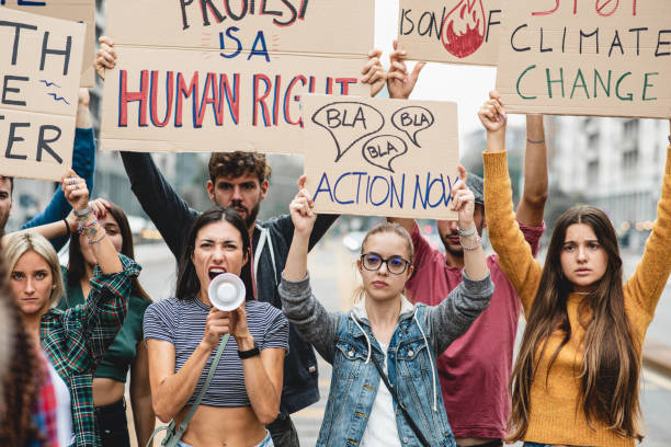 istock Group of multiethnic people making protest about climate change, public demonstration on the street against global warming and pollution. 1404007012