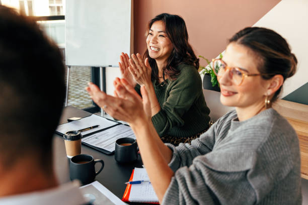 istock Happy businesspeople applauding during a meeting 1404007253