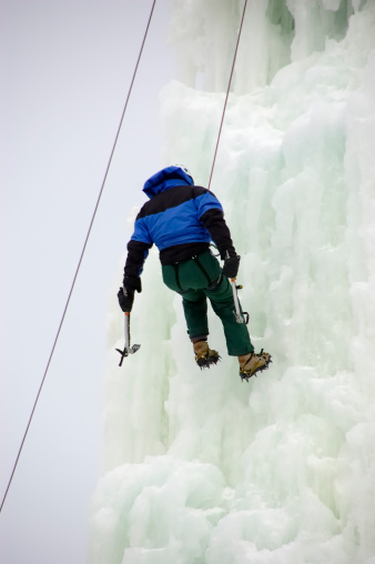 Ice Climber descending a cliff face