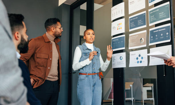 istock Young businesswoman discussing some reports with her team 1404007530