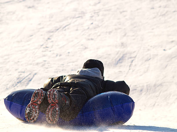 boy sledding stock photo