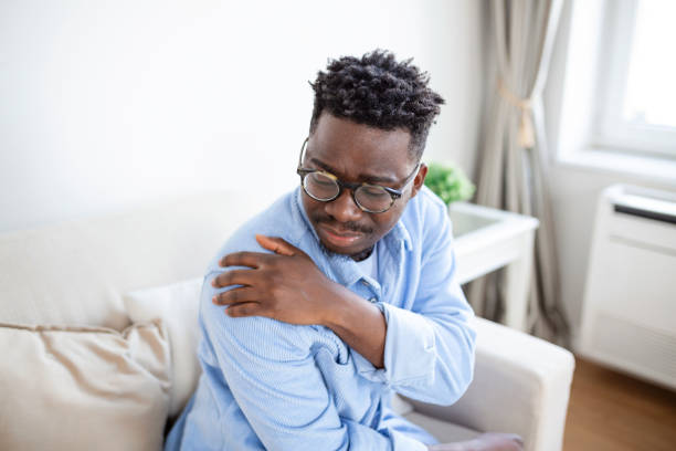 istock Tired man massaging stiff sore neck, tensed muscles fatigued from computer work in incorrect posture while feeling hurt joint shoulder back pain ache. Fibromyalgia concept 1404007954
